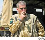 Pensive: Lt Col Tim Collins smokes a cigar after addressing his men